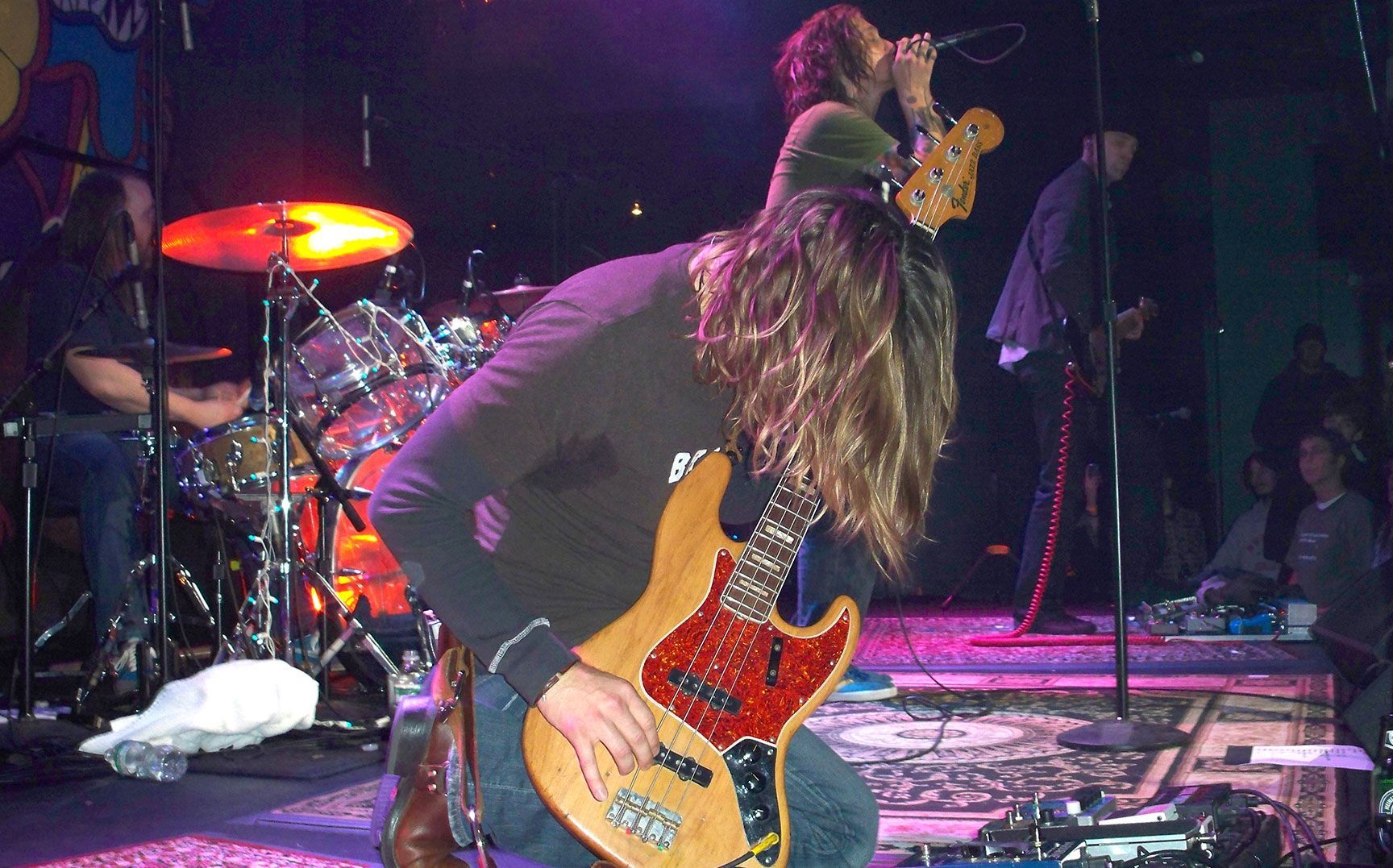 bass player performing on stage, kneeling, performance, Omaha, Nebraska