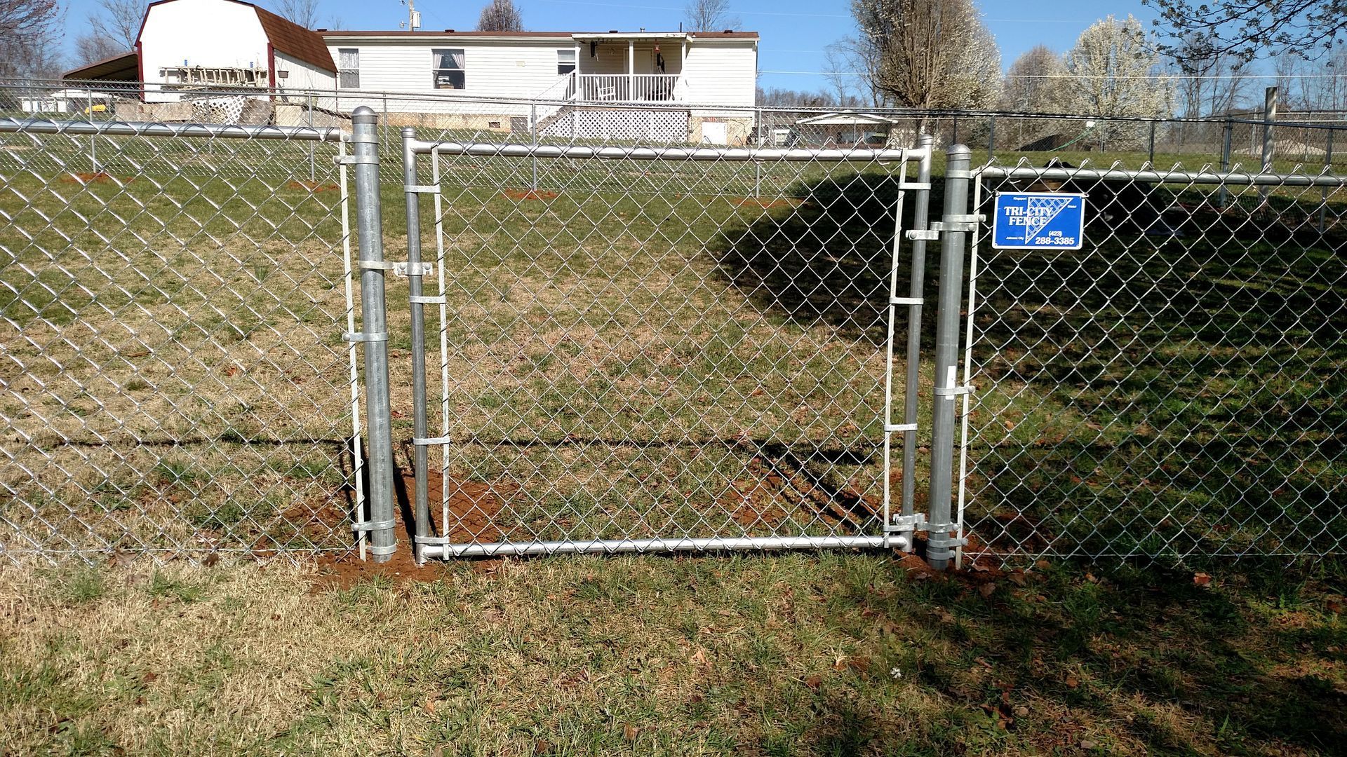 A chain link fence along the side of a road