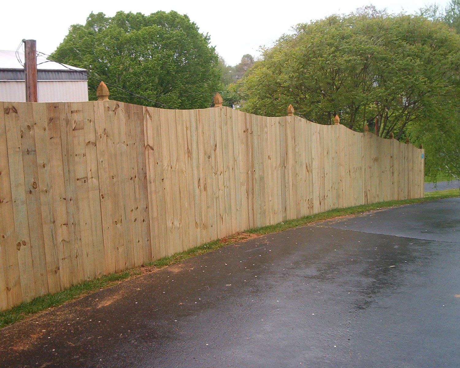 A wooden fence along the side of a road