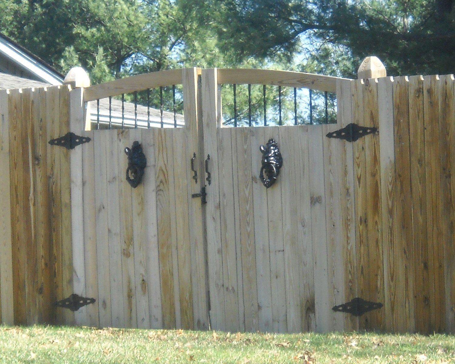 A wooden fence with a gate in the middle of it