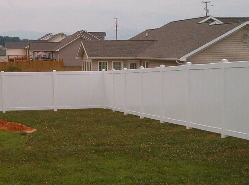 A modern house with a wooden fence around it.