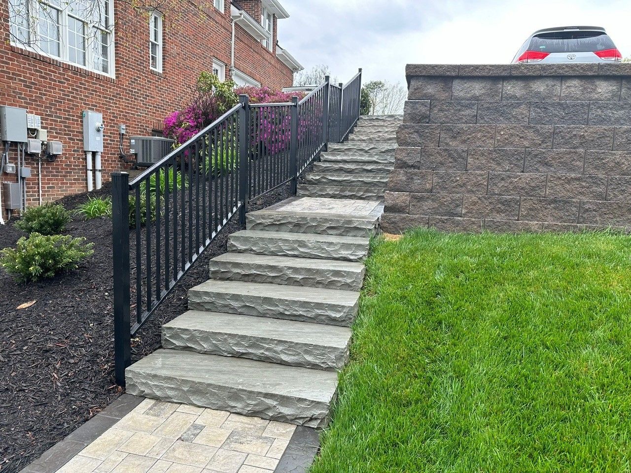 A set of stairs leading up to a house with a fence.