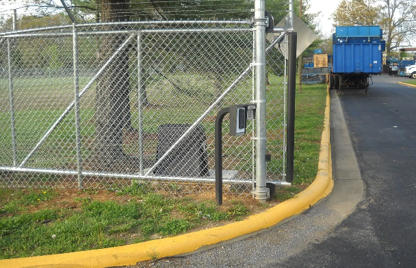 A person is opening a gate with a key.