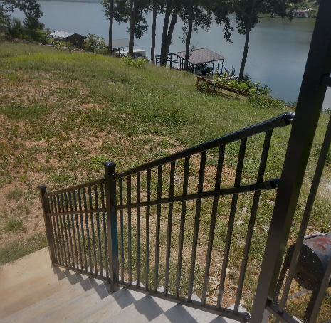 Stairs leading up to a lake with a dock in the background