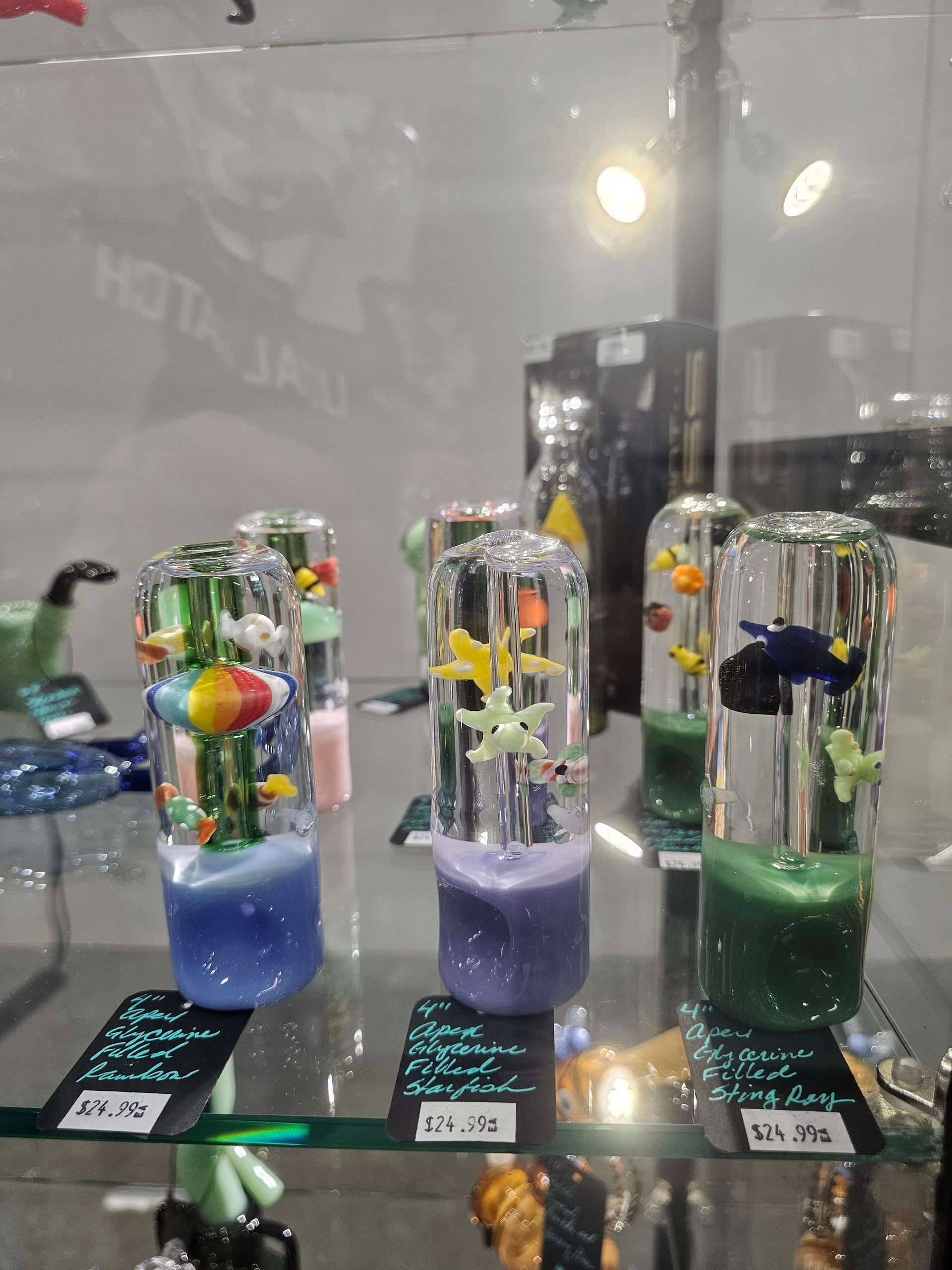 A glass display case filled with vape co. and glass products.
