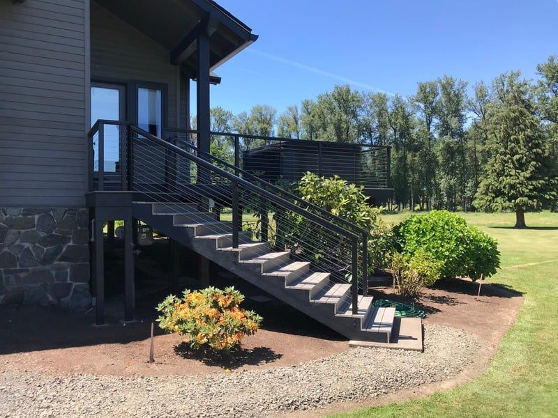 Partially constructed deck with exposed wooden frame. The background shows a pool, fence, and house.