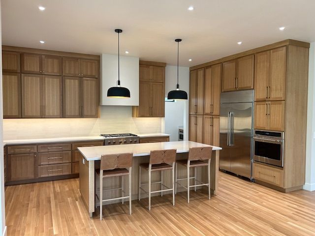 Kitchen under renovation; tools and materials scattered about. Interior view shows a partly finished space with open doorway to a finished kitchen.
