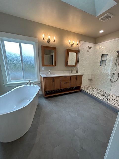 Living room with wooden floors, a white sectional sofa, brown accent wall, and dining area.
