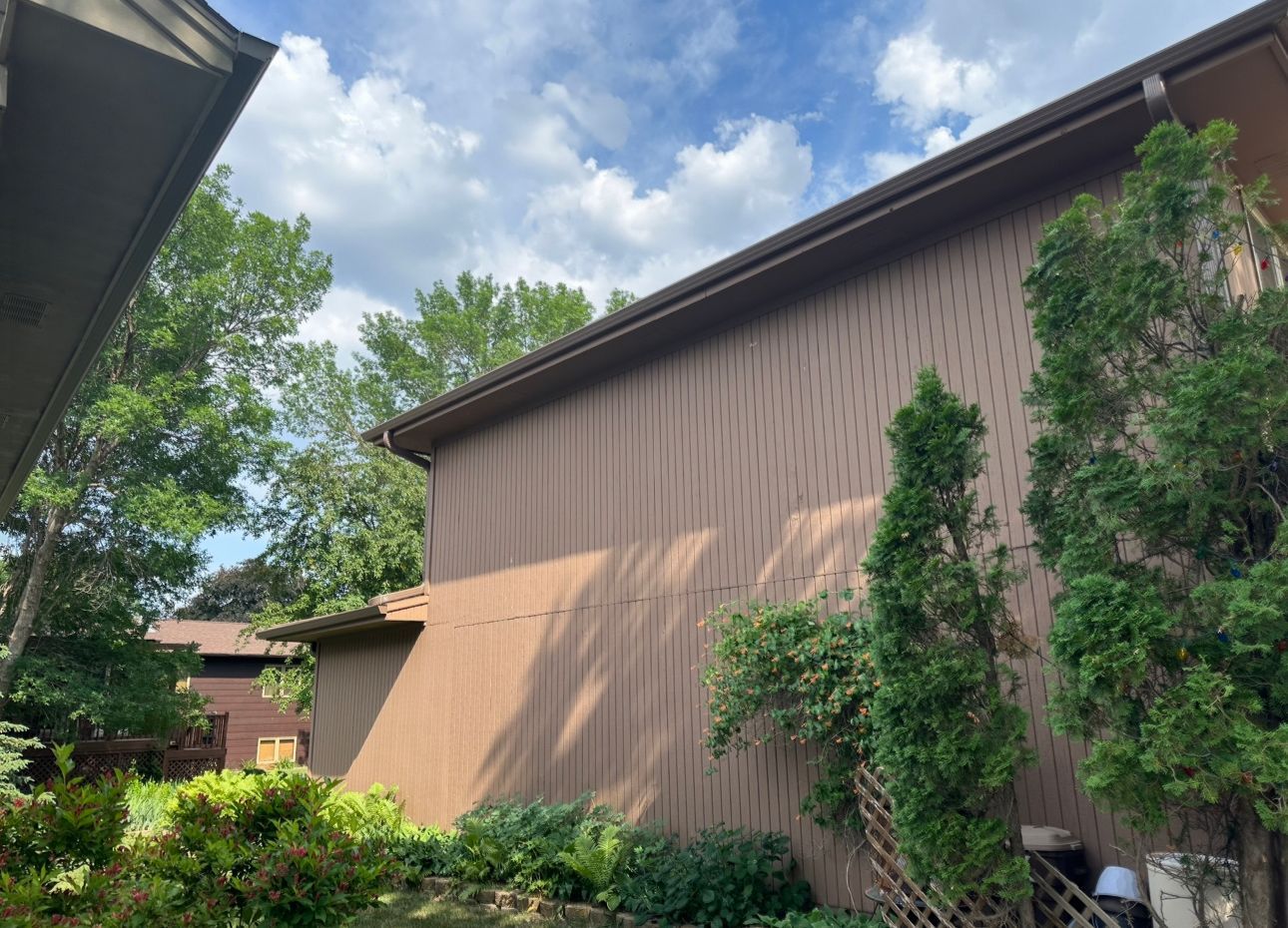 A house with a lot of trees in front of it