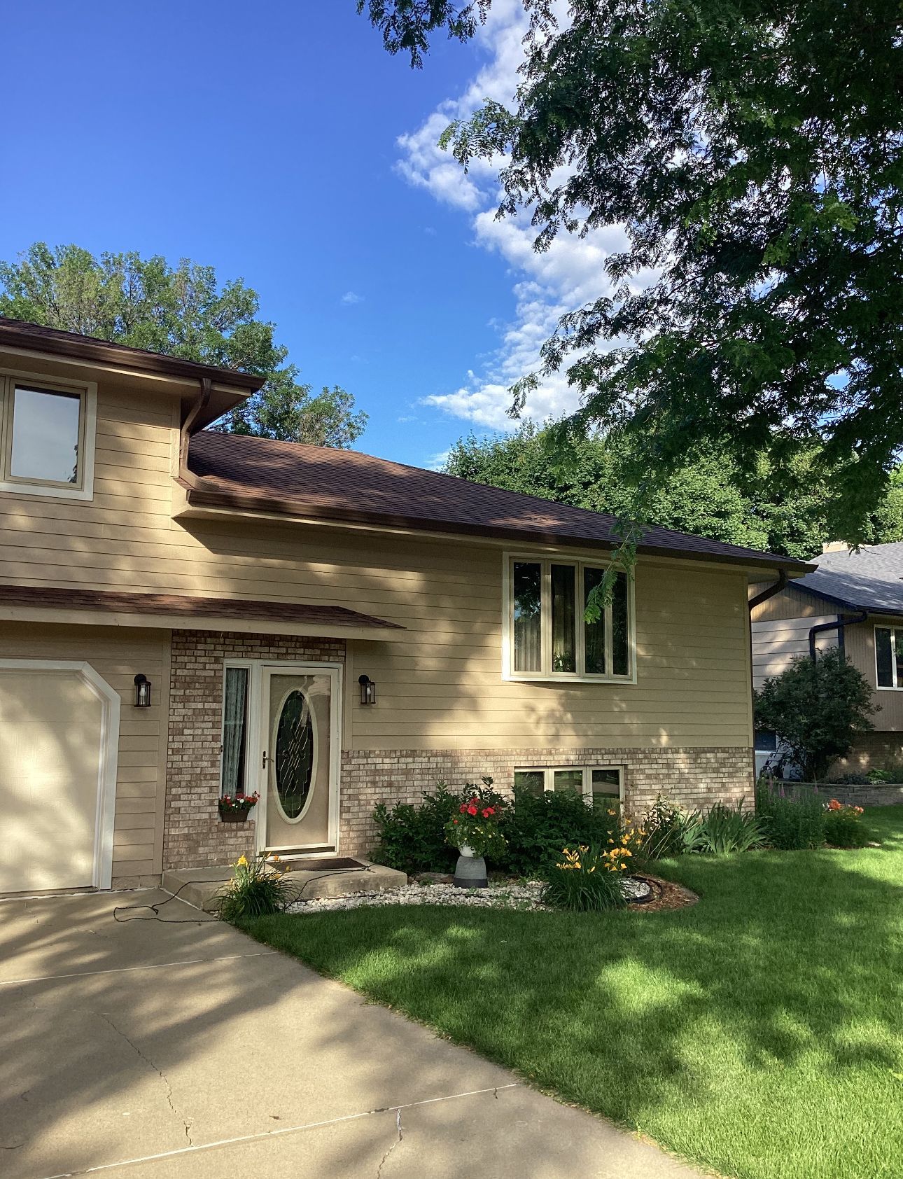 A house with a lot of windows and a driveway