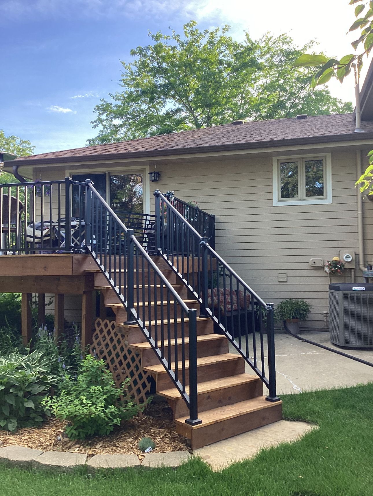 A house with a deck and stairs leading up to it.