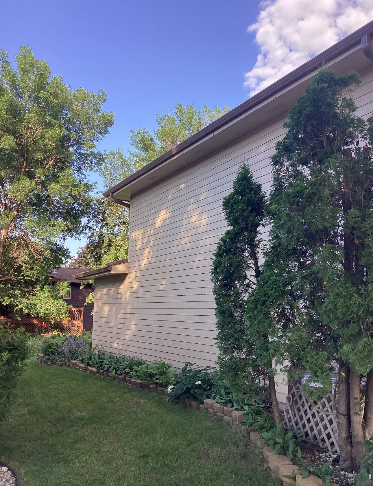 A house with a lot of trees in front of it.