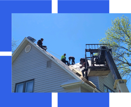 a group of men are working on the roof of a house