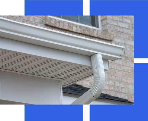 a white gutter is on the side of a brick building .