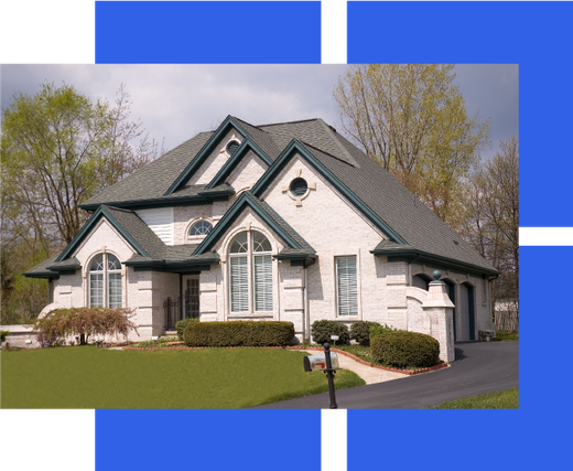 a large white house with green trim and a gray roof