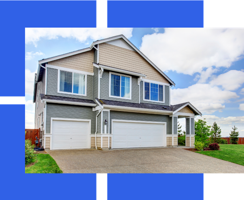 a large house with two garage doors and a driveway