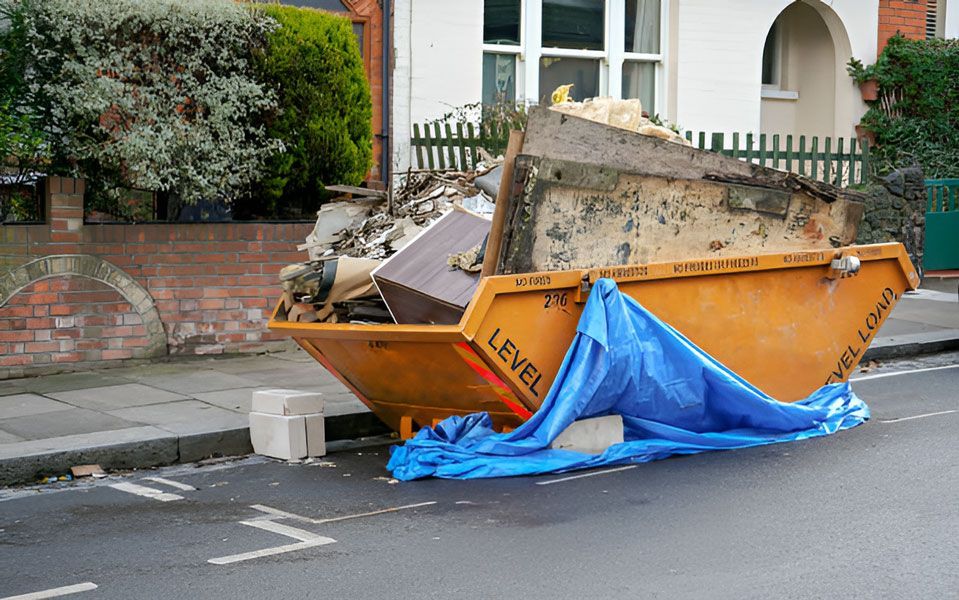 A Dumpster is Covered in a Blue Tarp on the Side of the Road — Swift Skips in Gympie, QLD