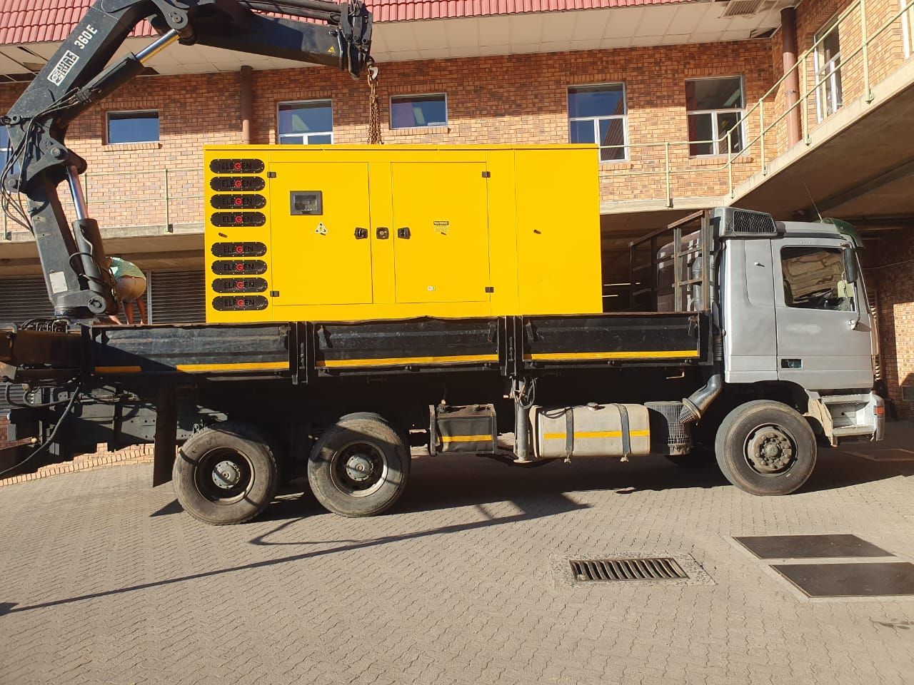 A truck with a yellow box on the back of it