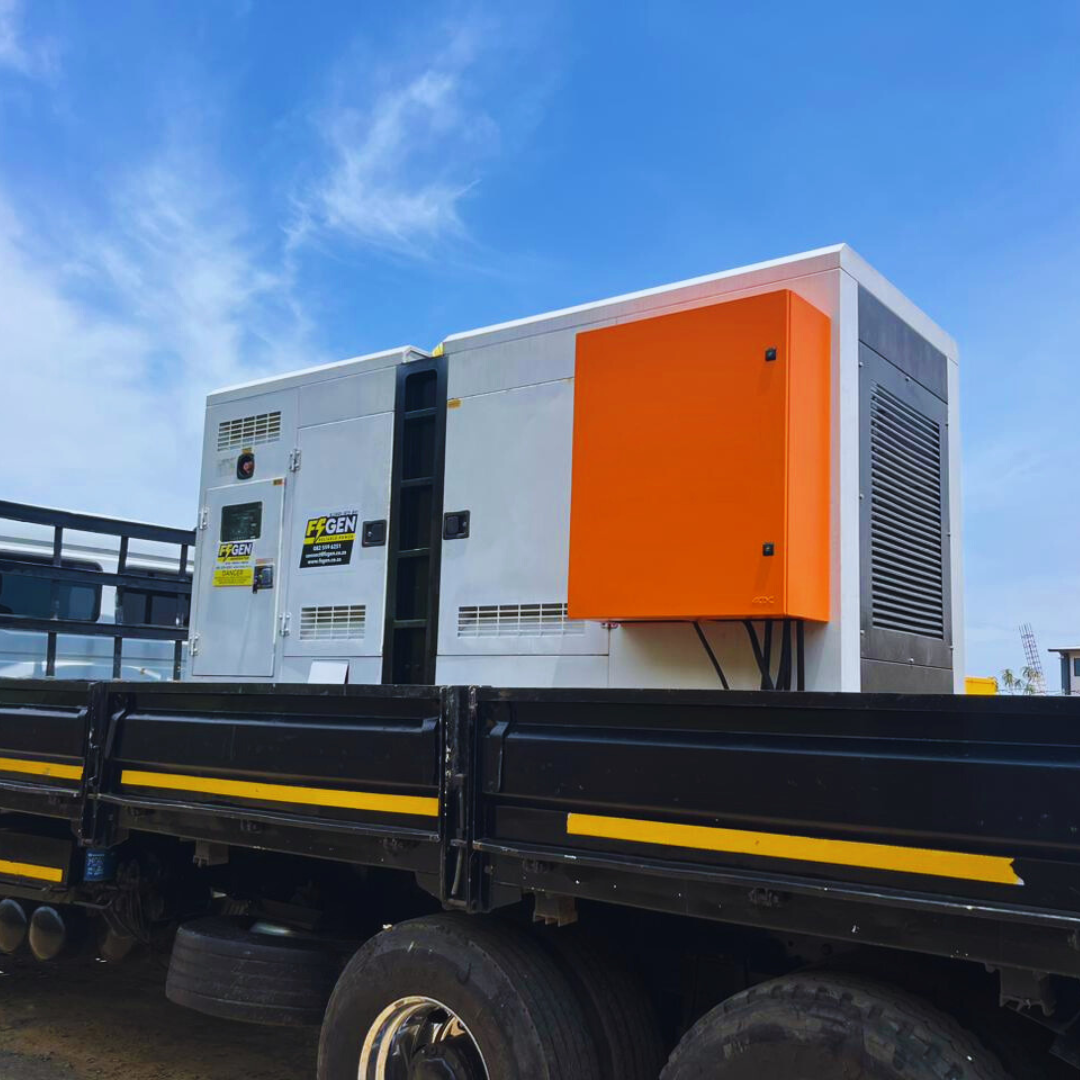 A black truck with an orange box on the back of it