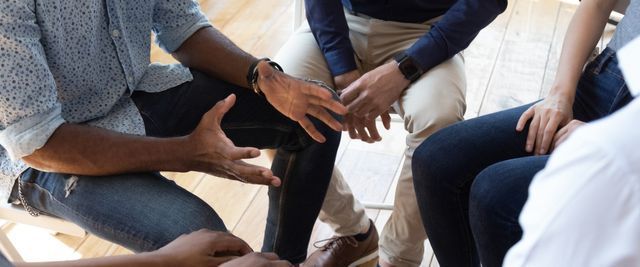 Group of people sitting with hands outstretched — Pennington, NJ — Mary J Goepfert - MSW MPA LCSW LCADC
