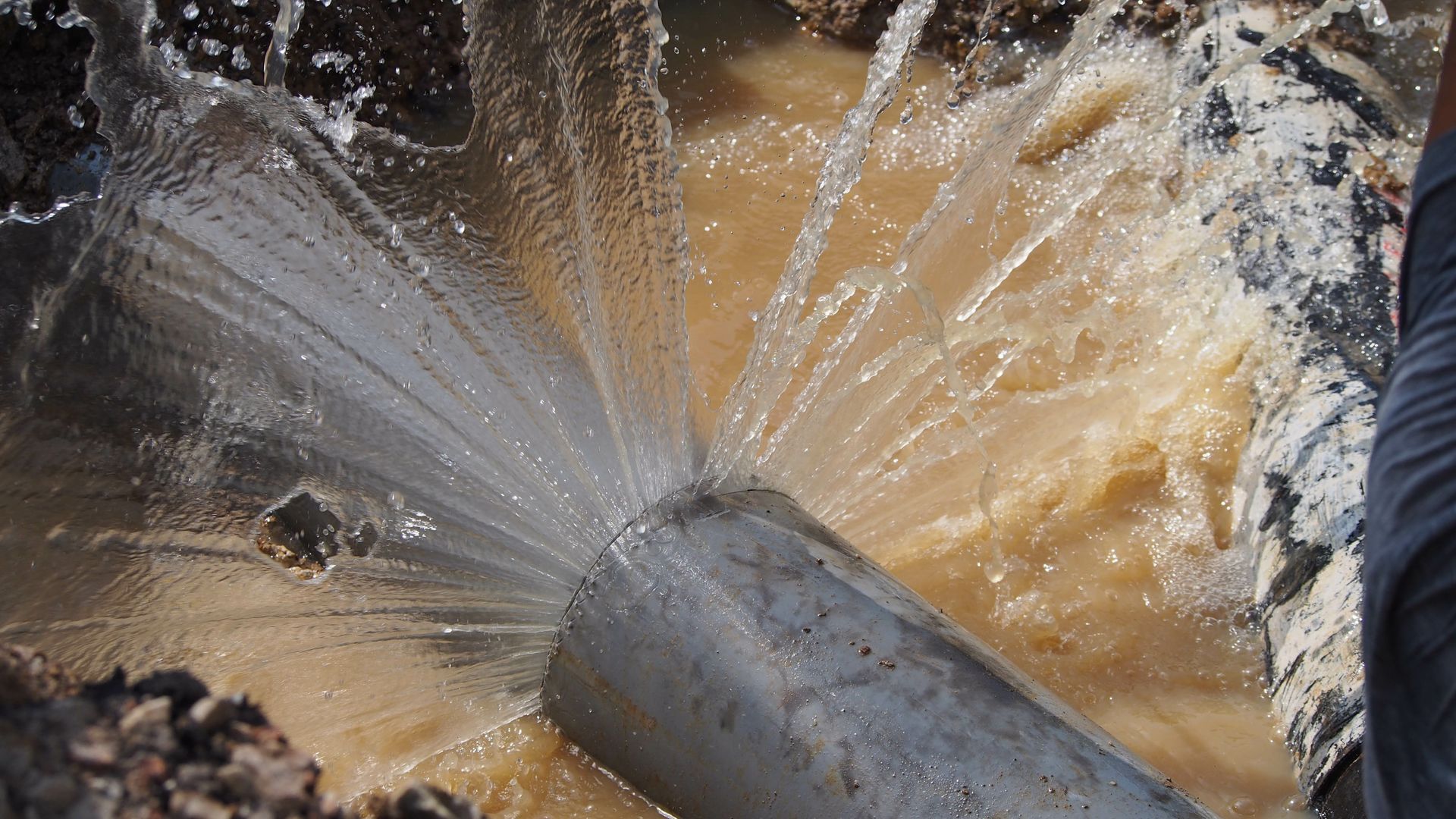 water is coming out of a hole in a pipe