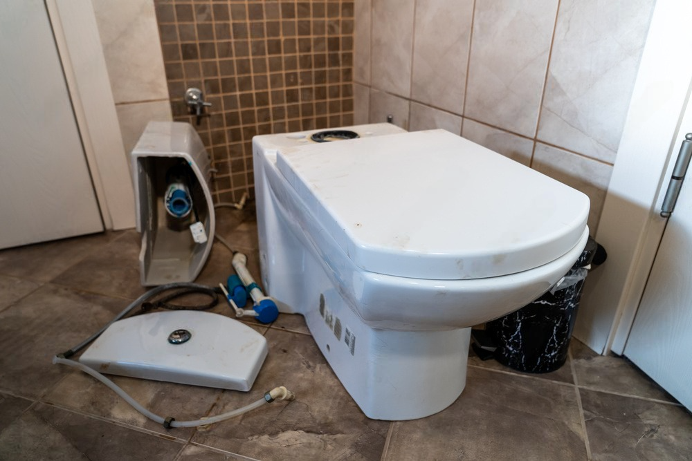 a toilet with the lid off is sitting on a tiled floor