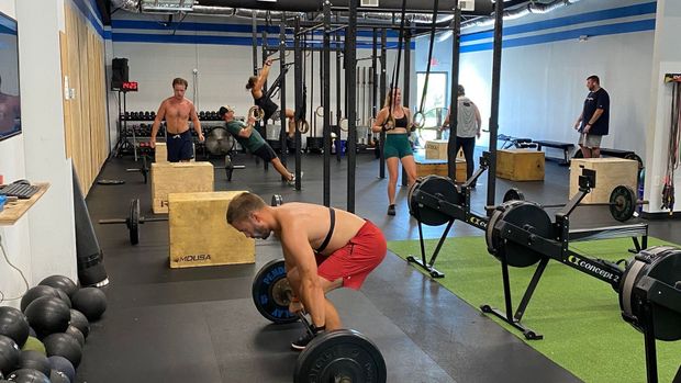 A group of people are working out in a gym.