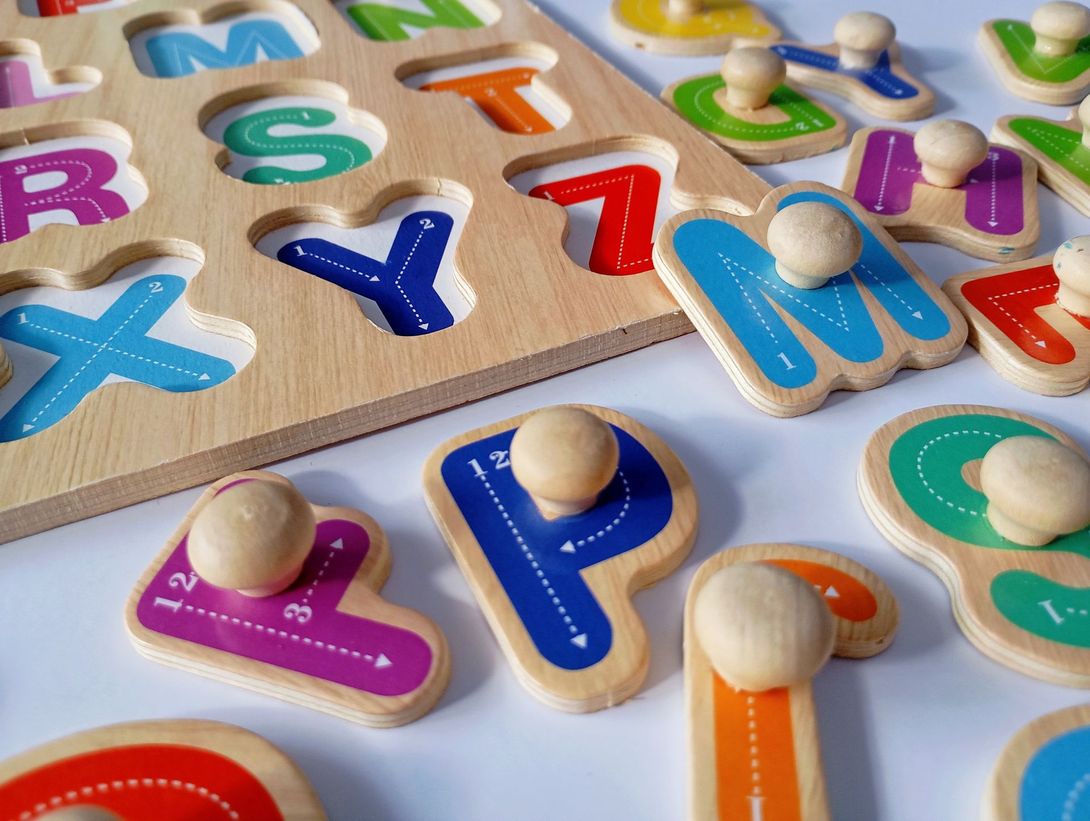 A wooden puzzle with the letters of the alphabet on it