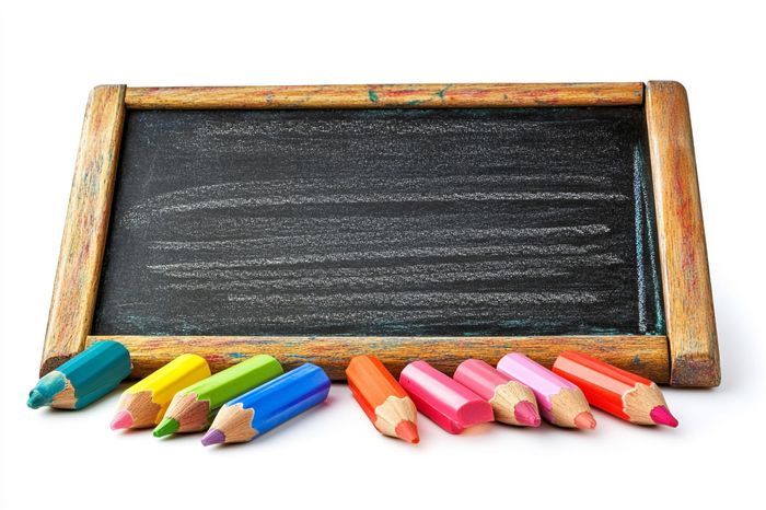 A blackboard with colored pencils on it