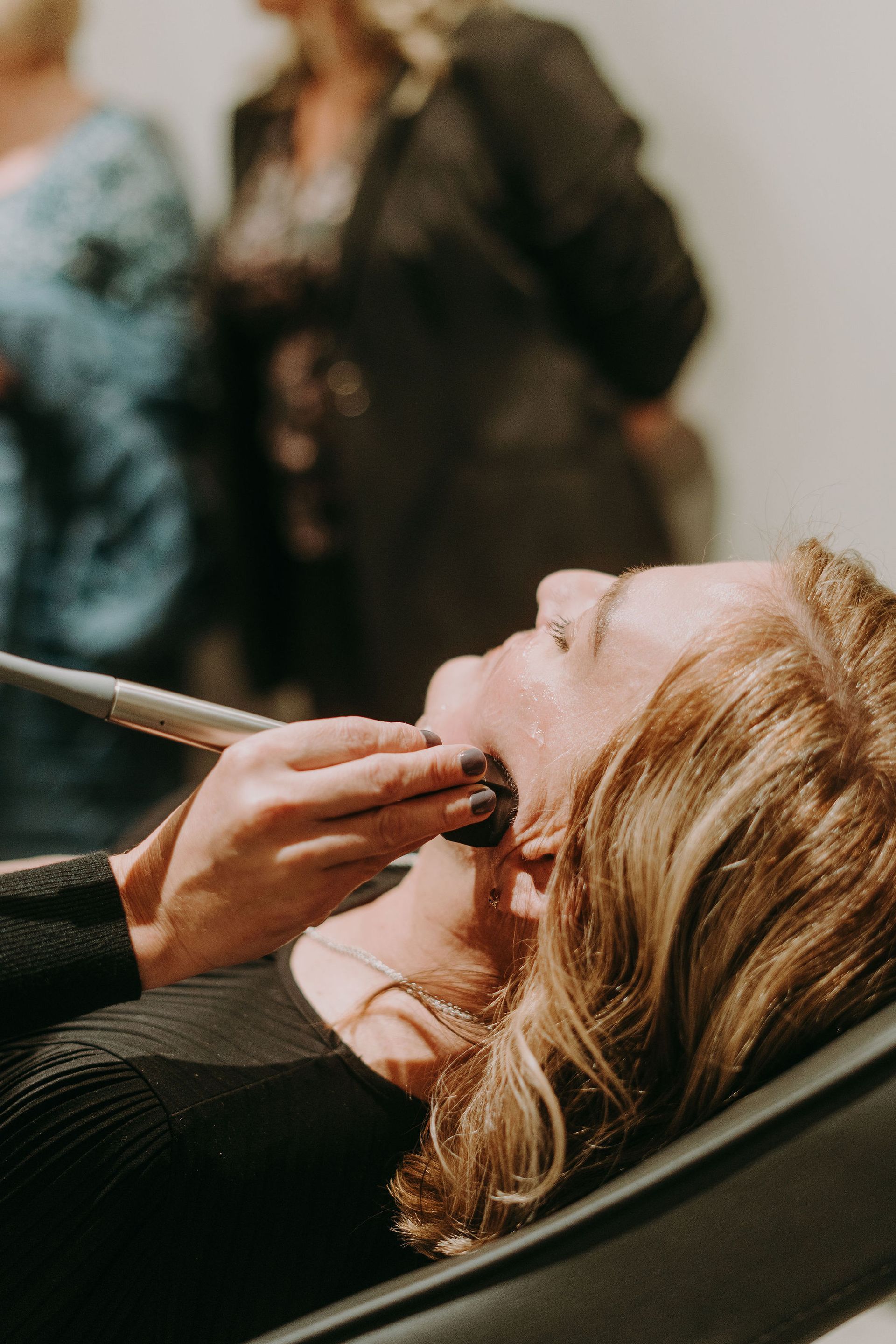 Woman receiving facial treatment with Forma RF
