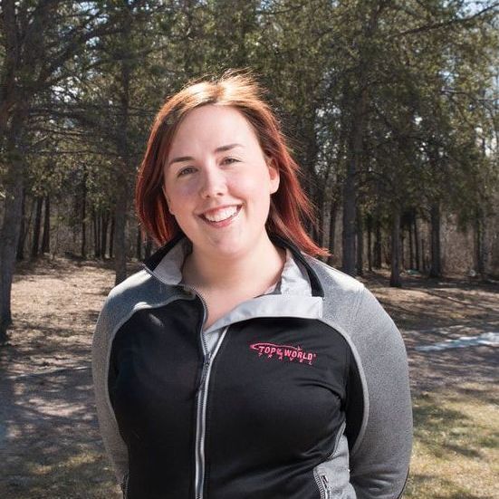 A woman wearing a patagonia jacket smiles for the camera