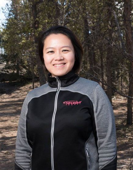 A woman wearing a grey and black jacket with the word chicago on it