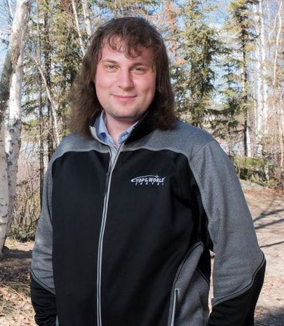 A man with long hair is wearing a columbia jacket