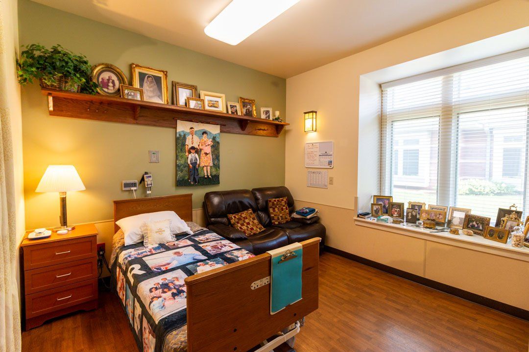 There is a bed and a couch in the room.