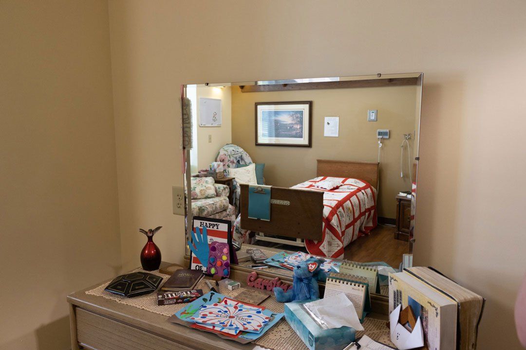 A bedroom with a bed and a mirror on the wall.