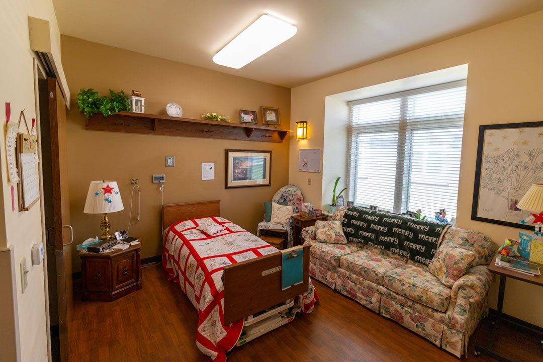 There is a bed and a couch in the room.