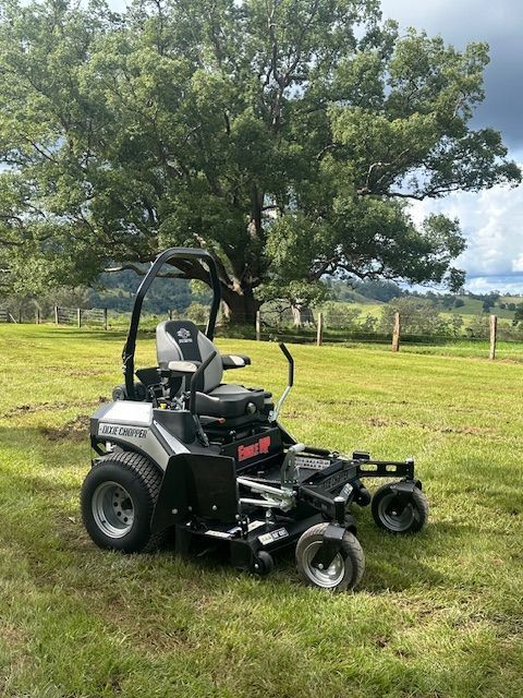 Grey Ride Mower in a Grassy Field — Mower Shop In Murwillumbah, NSW