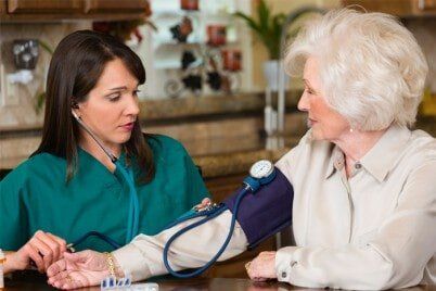 Nurse Taking Blood Pressure of a Elder Patient - Home Health Aide in Joliet, IL