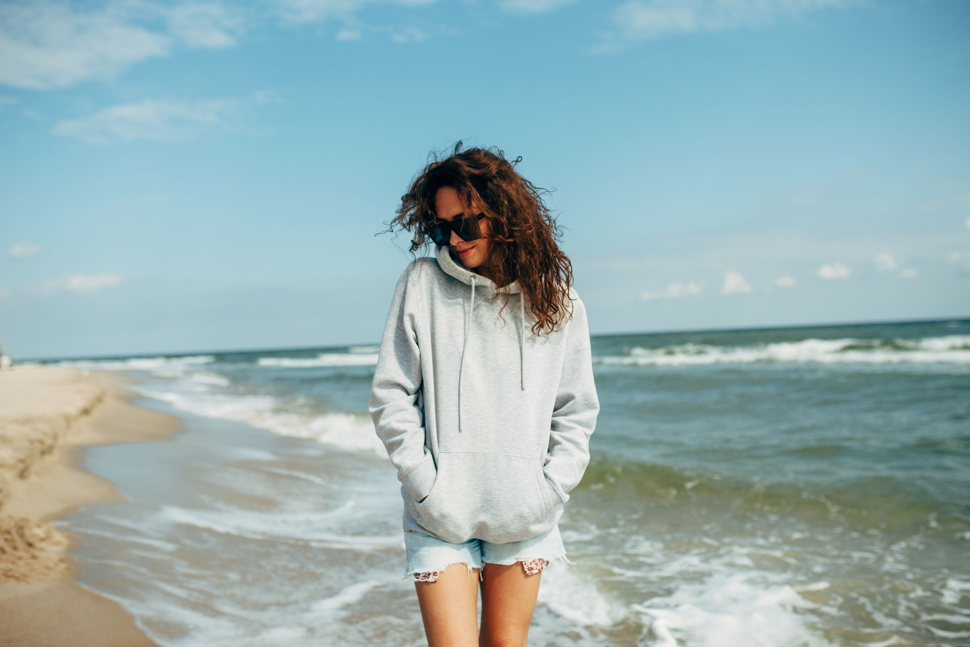 Wearing a grey hoodie and denim shorts