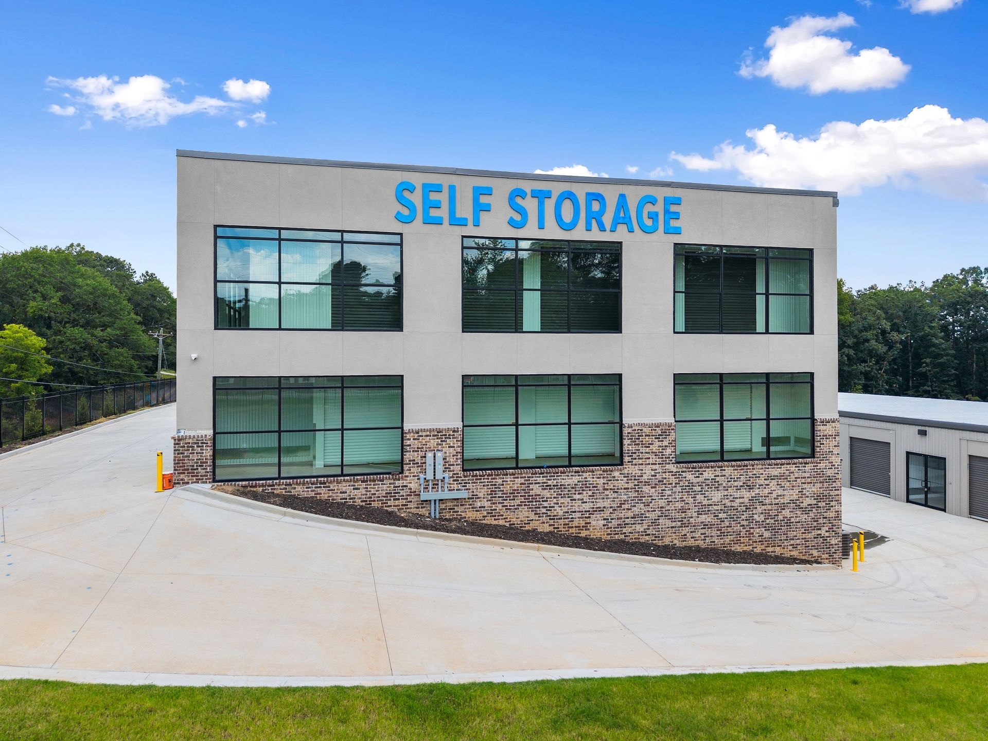 A man is pushing a cart filled with boxes in a warehouse.