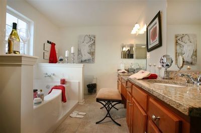 A bathroom with a tub , sink and mirror