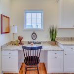 There is a desk with a chair in the middle of the room.