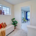 A living room with a bench and a window.
