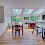 There is a table and chairs in the middle of the room.