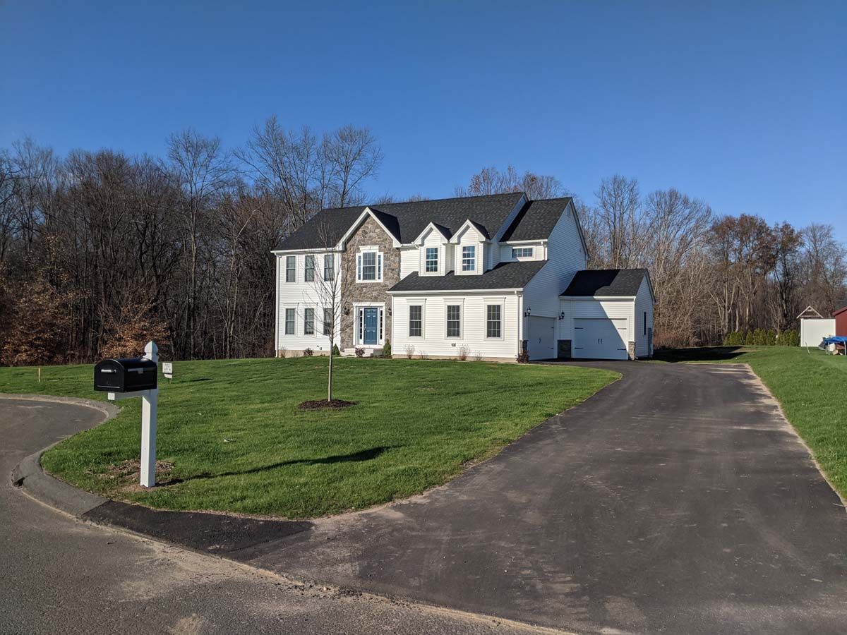 A large white house with a mailbox in front of it