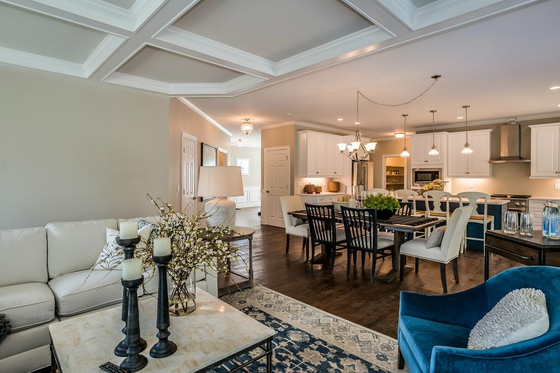 A living room with a couch , chair , table , and candles.
