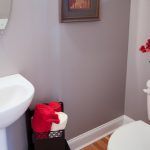 A bathroom with a sink , toilet , and mirror.