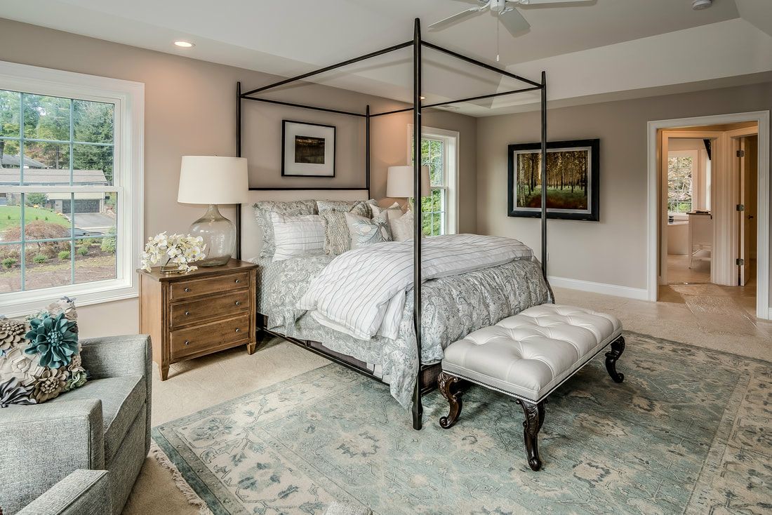 There is a canopy bed in the middle of the room.