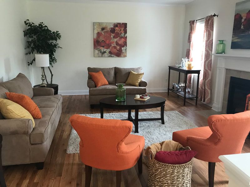 A living room with a couch and chairs and a fireplace
