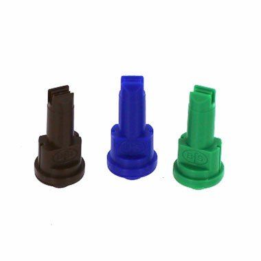 three different colored spray nozzles are sitting next to each other on a white surface .